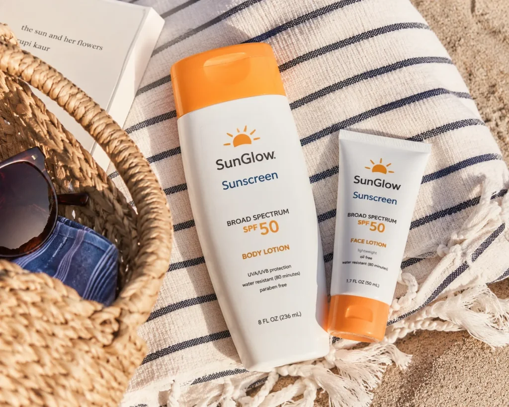 11 La Roche Posay Sunscreen Tips for a Healthy Glow 8 Body sunscreen and facial sunscreen bottles on a striped beach towel