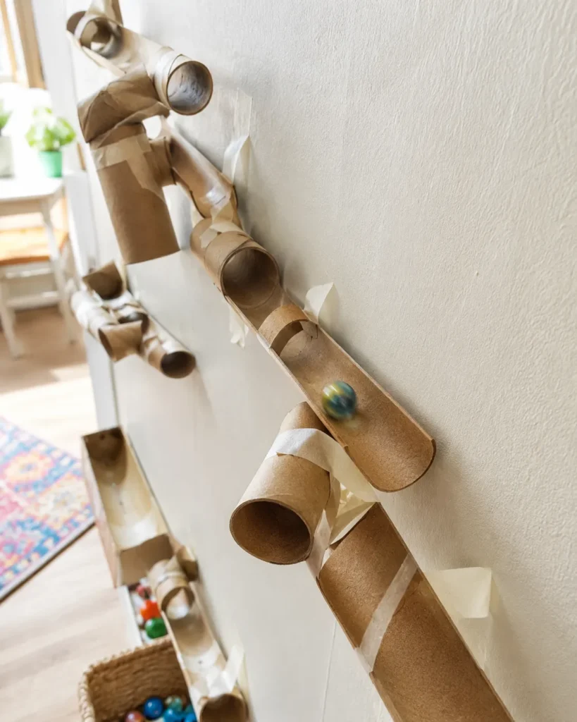12 Kids Activities That Spark Creativity at Home Today 9 Homemade marble run built from toilet paper rolls with a marble mid roll