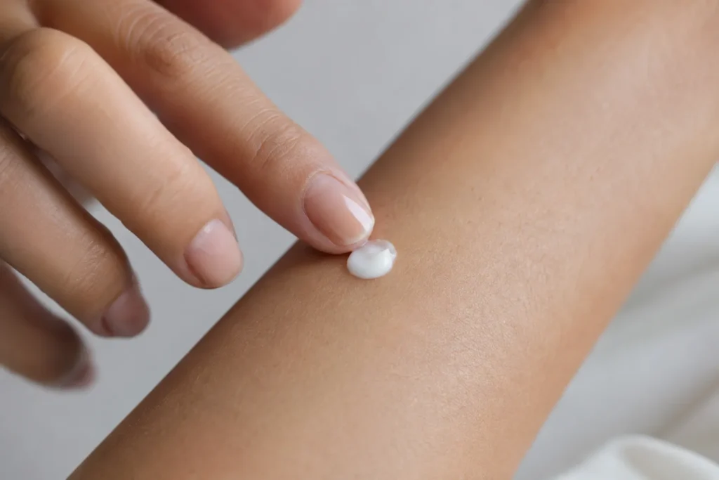 12 Sensitive Skin Care Steps for a Fresh Glow 2 Hand applying a small patch test dot of cream to the inner forearm before full use"