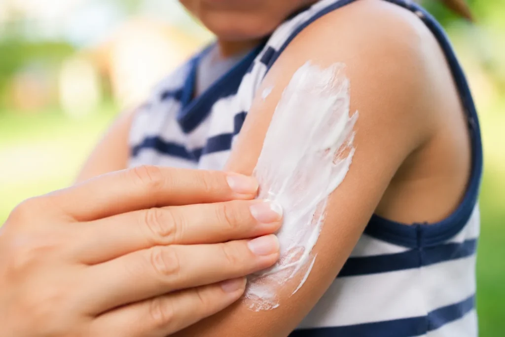 10 Kids Sunscreen Facts Every Parent Should Know 5 Thick layer of sunscreen being applied to a child's arm