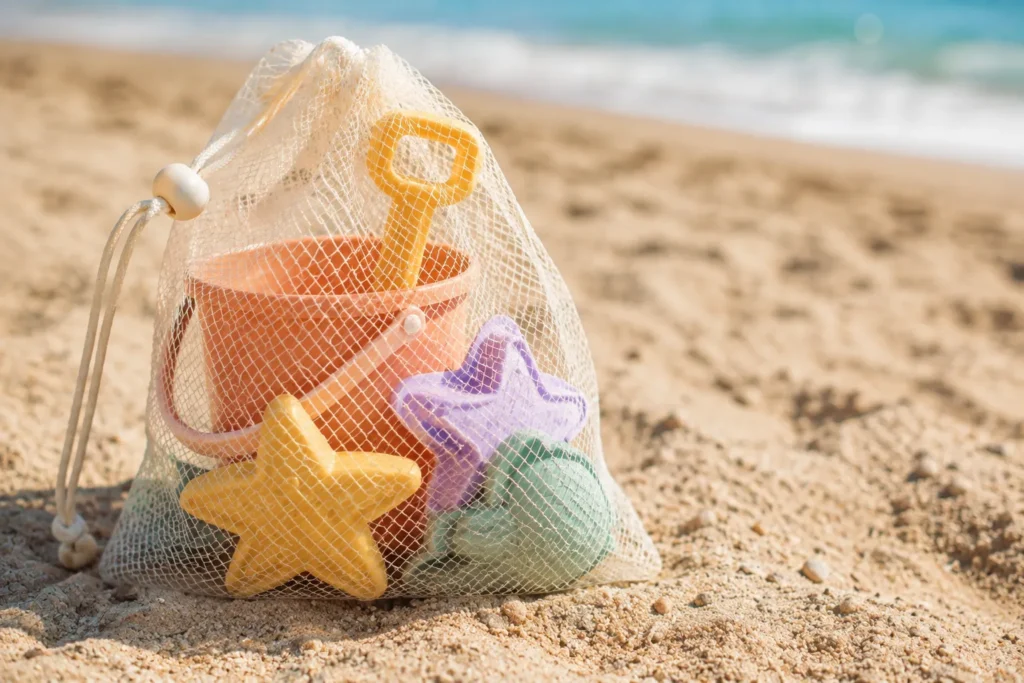 11 Beach Kids Ideas for a Perfect Family Beach Day 4 Mesh sand toy bag with shovel, bucket, and molds for beach play